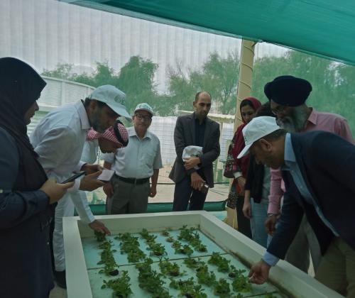 A group of people gathered around some plants