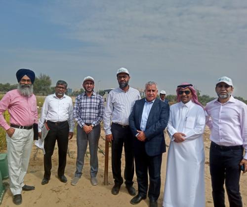 A group of people standing in the desert