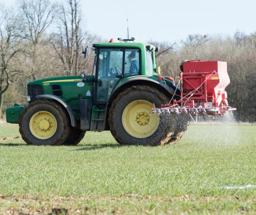 tractor spraying fertiliser in the field
