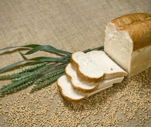 Loaf of bread with wheat plants