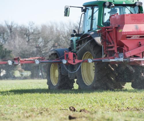 Tractor spreading fertiliser