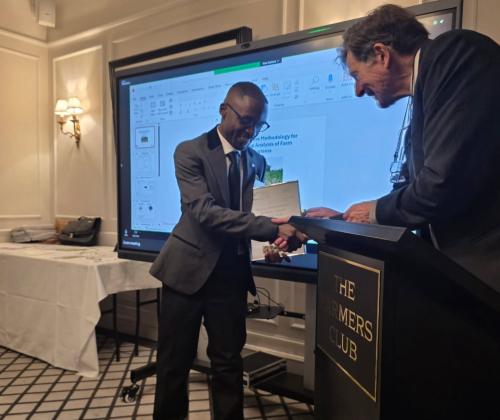 chawezi shaking hands with a man to accept his award